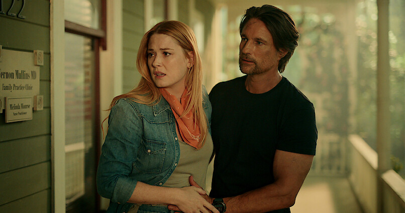 Alexandra Breckenridge as Mel Monroe and Martin Henderson as Jack Sheridan stand on a porch looking concerned in Season 5 of 'Virgin River.'