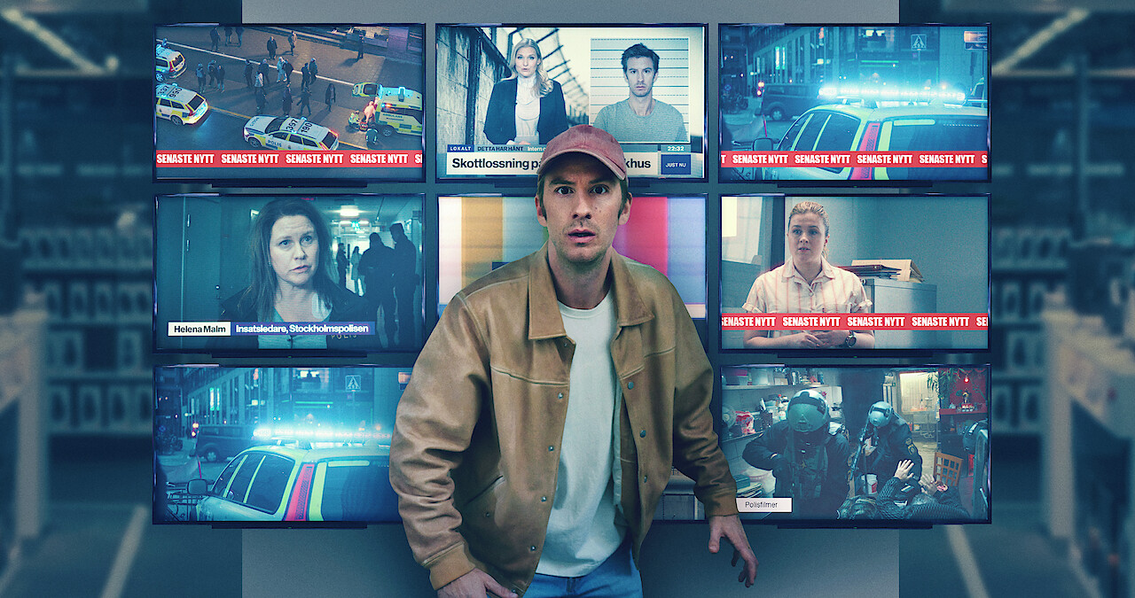 In an image from the film 'Trouble,' Filip Berg as Conny stands in front of nine TV screens showing various news reports.