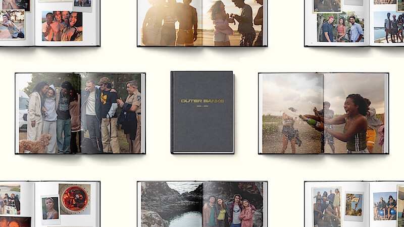 Photo books open to various pages showing groups of friends, outdoor settings, celebrations, and candid moments, arranged around a closed book with “OUR FAMILY SNAPBOOK” on the cover, all set against a light background.
