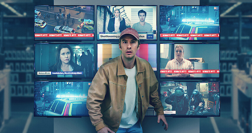 In an image from the film 'Trouble,' Filip Berg as Conny stands in front of nine TV screens showing various news reports.