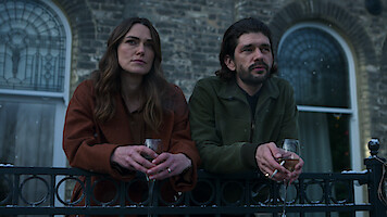 Keira Knightley and Ben Whishaw lean on a railing together in Season 1 of 'Black Doves'