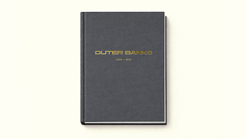 A black hardcover book with gold "Outer Banks 2020–2025" text on the cover, photographed on a plain off-white background.