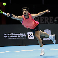 Carlos Alcaraz hitting an outstretched forehand shot during The 2024 6 Kings Slam