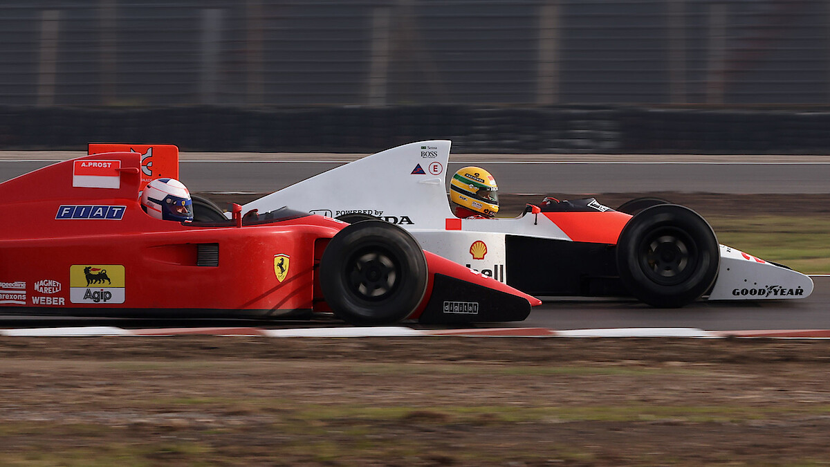 A warehouse with three F1 car models 