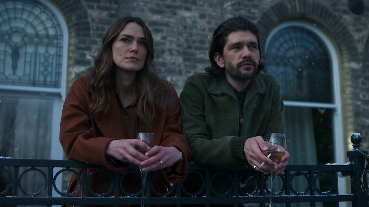 Keira Knightley and Ben Whishaw lean on a railing together in Season 1 of 'Black Doves'
