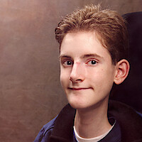 Mats Steen wears a white shirt and blue jacket and smiles slightly.