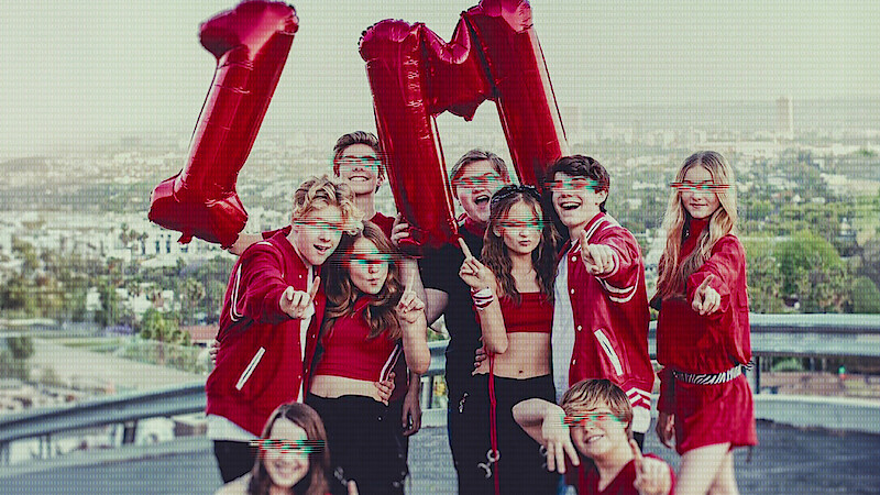 Kidfluencers pose with balloons that say 1M