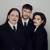 Jessica Gunning, Richard Gadd, and Nava Mau wear suits and pose against a light gray background.