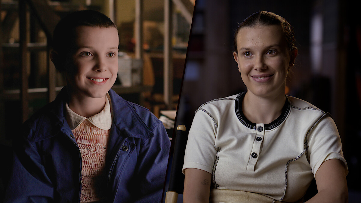 A split-screen contrasts Millie Bobby Brown in Season 1, with short hair and a blue jacket, smiling in a brightly lit room, and her Season 5 look, wearing a white shirt and smiling softly in a dimly lit indoor setting.