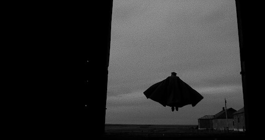 A vampire soars in the air in this black and white still from 'El Conde' directed by Pablo Larraín.