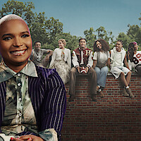 Felicia Pride smiling against A Different World Cast Photo