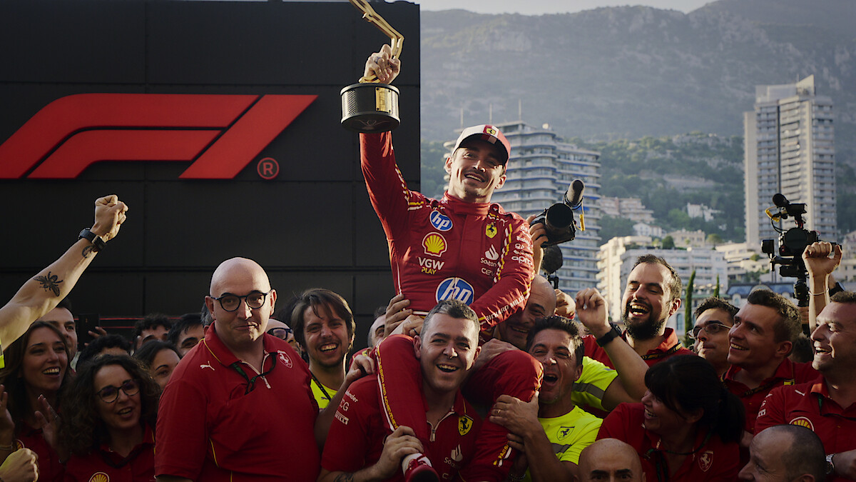 Charles Leclerc lifting a trophy as he is carried by his team in 'Formula 1: Drive to Survive' Season 6