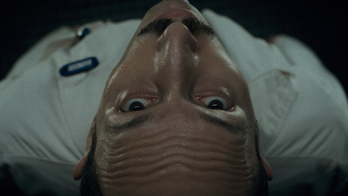 Overhead angle of a man looking up with a fearful expression