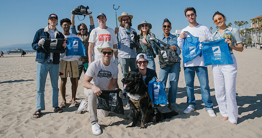 The 'Outer Banks' cast and crew participate in a beach cleanup.