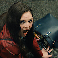 Meg Stalter as Jessica looking up in shock