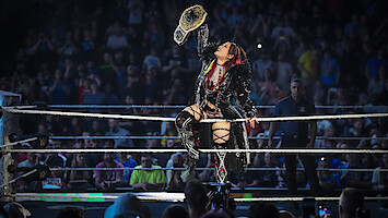 IYO SKY holds up her belt in the ring