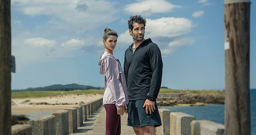 Clara Lago as Ana and Tamar Novas as Daniel stand together on a dock in 'Gangs of Galicia'