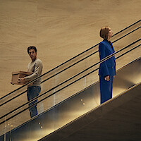 Ladies First. (L-R) Sacha Baron Cohen as Damien Sachs and Rosamund Pike as Alex Fox in Ladies First. Cr. Rob Youngson/Netflix © 2026.