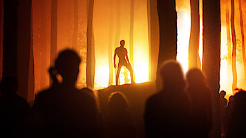 A shadow figure stands in a forest backlit by golden light in Season 1 of 'Joko Anwar’s Nightmares and Daydreams'