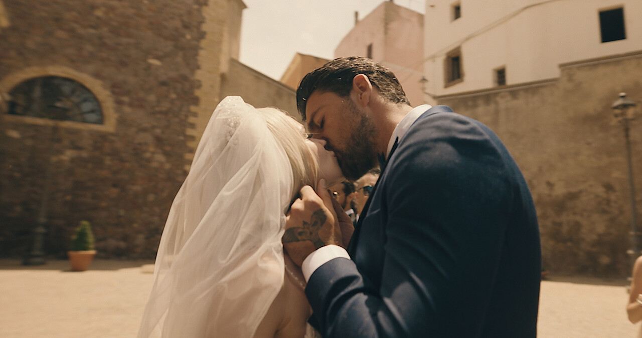 Massimo kisses Laura on their wedding day