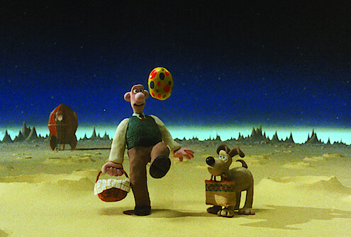 Wallace and Gromit stand on the surface of the moon.