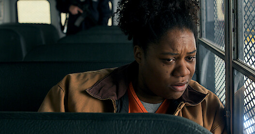 Adrienne C. Moore as Cindy sitting on a bus in Orange Is the New Black Season 6.