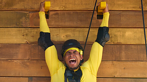 Louis yells while doing a climbing challenge.