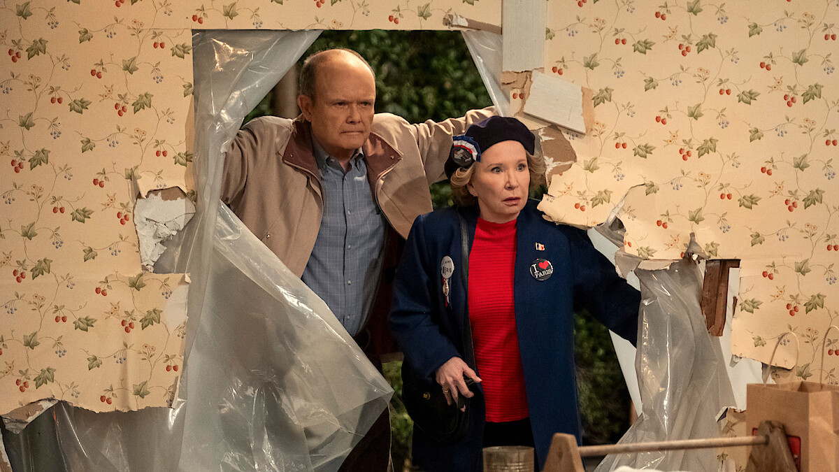 Red and Kitty walk through an open hole in their house in Part 3 of 'That '90s Show'