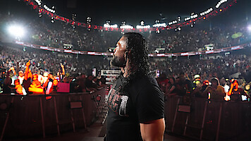 Roman Reigns surrounded by the crowd at WWE Raw