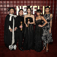 KPop Demon Hunters creators and cast hold their Golden Globe statuettes at the Netflix after party after the 2026 awards ceremony.