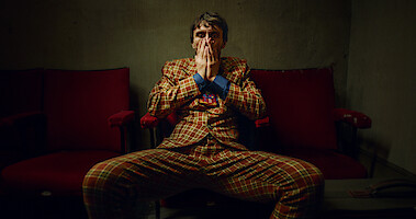 Richard Gadd as Donny Dunn wears a plaid suit and shows a stressed expression in 'Baby Reindeer'