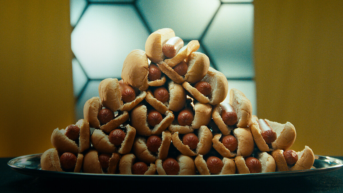 A plate piled high with hot dogs.