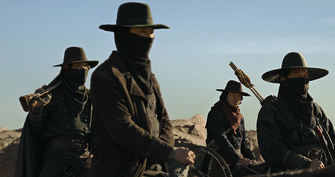 A group of people ride horses wearing all black in Season 1 of 'Song of the Bandits.'