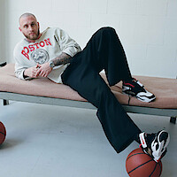 Chet Hanks on cot with basketball