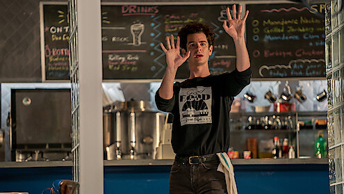 Andrew Garfield in a cafe scene in tick, tick... Boom!