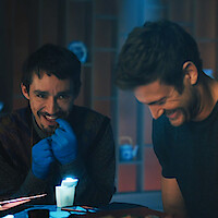 Robert Sheehan as Klaus and Tom Hopper as Luther laugh together in the bloopers for Season 4 of 'The Umbrella Academy'
