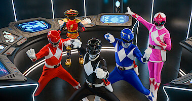 The Red, Black, Blue, and Pink Rangers in fighting stances, with Alpha 9 looking on, in a still from Mighty Morphin Power Rangers: Once & Always.