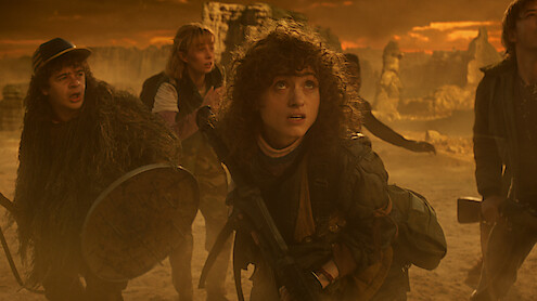 Gaten Matarazzo as Dustin Henderson, Maya Hawke as Robin Buckley, and Natalia Dyer as Nancy Wheeler in 'Stranger Things 5'