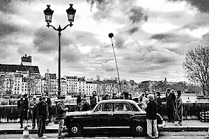 Cast and crew film Nouvelle Vague in the streets of Paris.