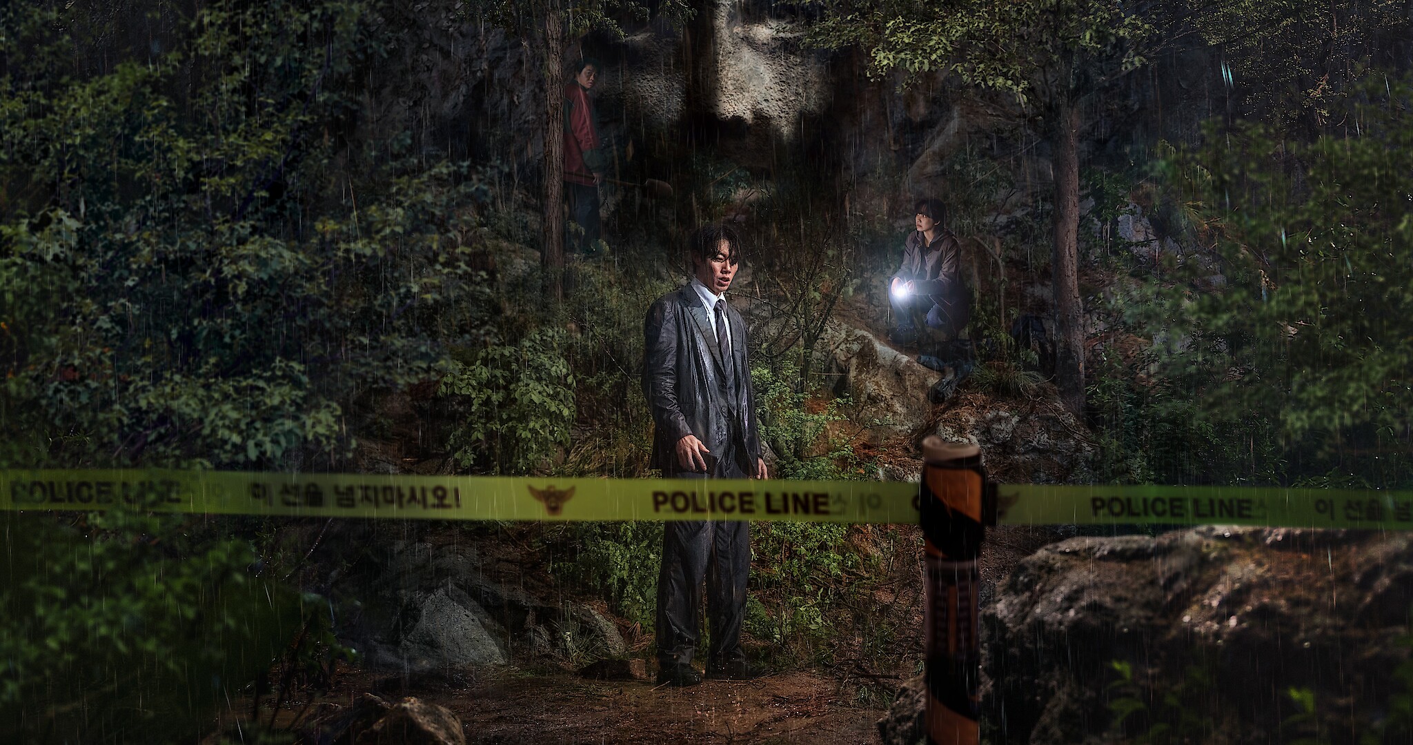 Revelations key art - Two detectives standing behind police line tape in a dark wooded forest area. 