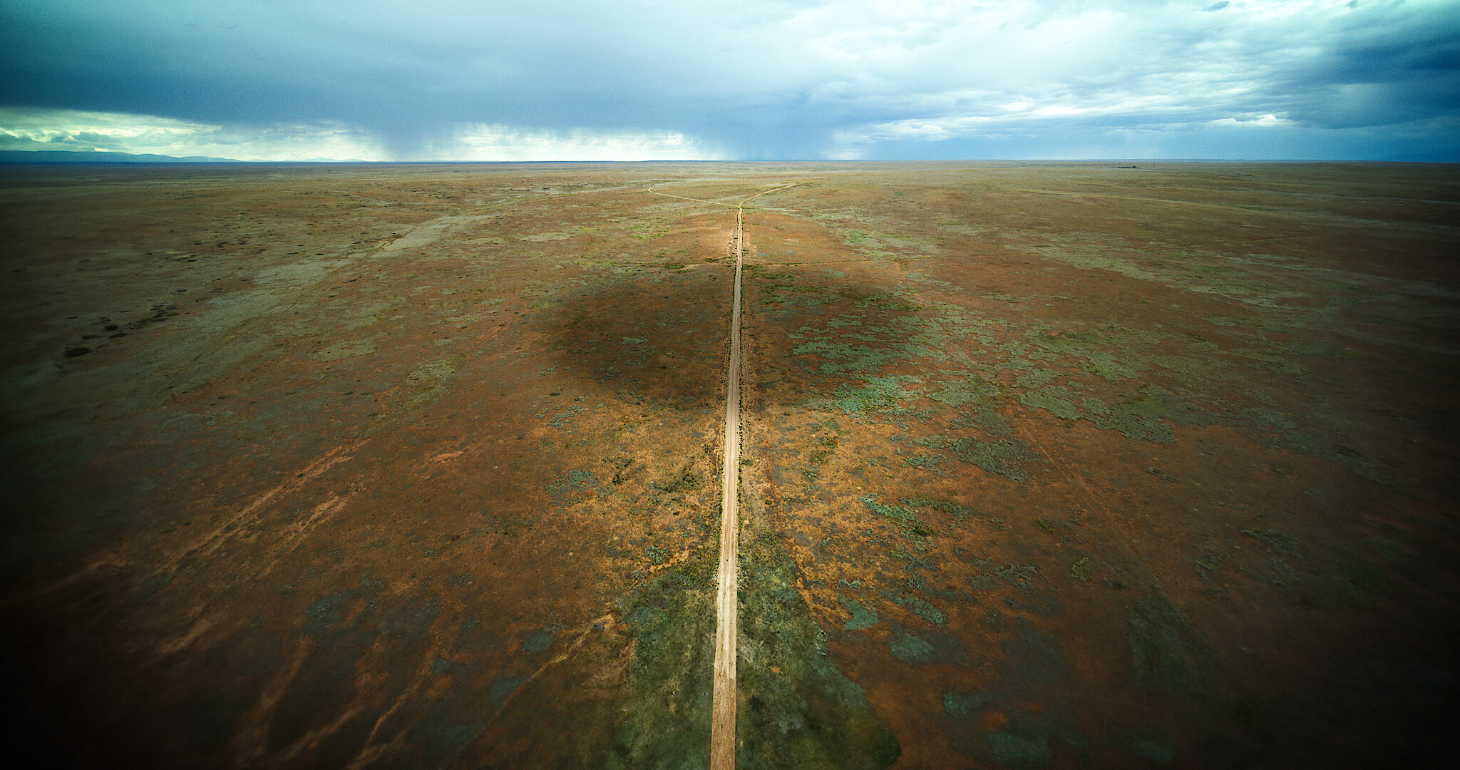 A view of a field with an ominous shadow 