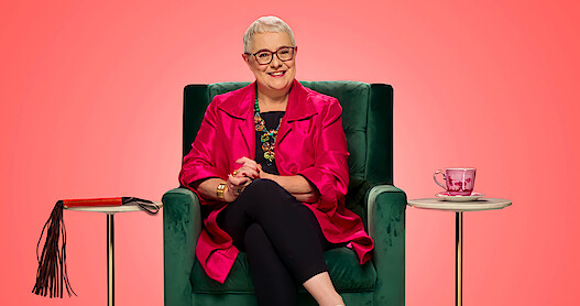 Woman sitting on chair smiling big