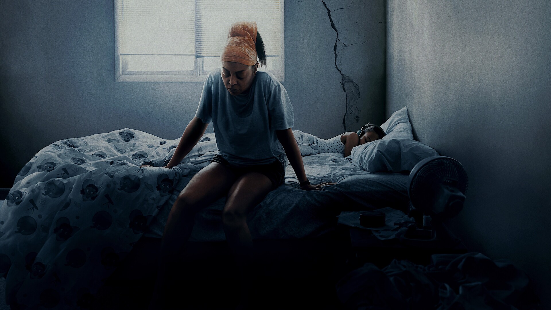 STRAW - A woman sitting on the edge of a bed