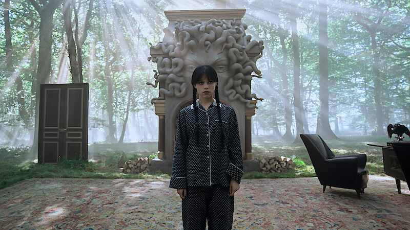 Jenna Ortega as Wednesday Addams holding an eyeball with tongs in 'Wednesday' Season 2. 