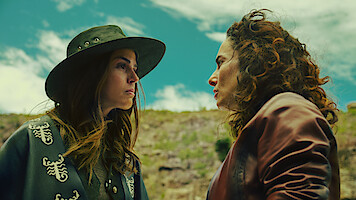 Claudia Alvarez as Antonia and Ana Serradilla as Perla look at each other angrily while outside in an image from 'Sisters' Feud.'