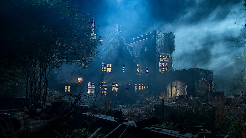 Old, abandoned mansion at night surrounded by overgrown vegetation, eerie mist, and dramatic lighting creating a spooky, haunted atmosphere. Broken windows and ruined walls add to the mysterious, unsettling mood of the scene.