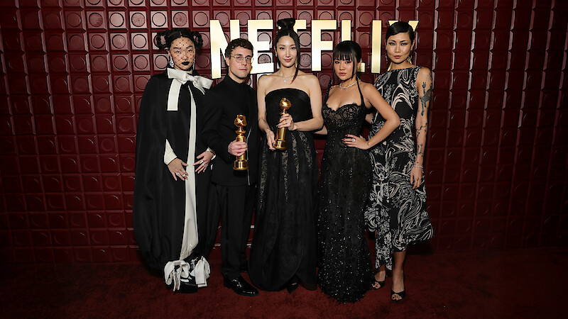 KPop Demon Hunters creators and cast hold their Golden Globe statuettes at the Netflix after party after the 2026 awards ceremony.