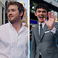 Split image: left side shows Kit Connor in a white shirt outdoors with historic buildings behind; right side shows Joe Locke in a striped suit waving and smiling at an event with neon signage and crowds in the background.