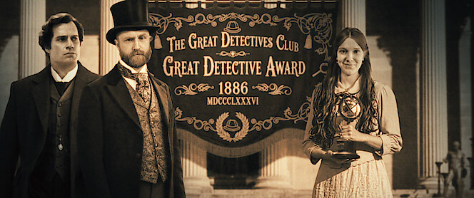 Three people in Victorian-era attire stand before a banner reading "The Great Detectives Club Great Detective Award 1886"; one woman holds a trophy, the scene set within grand architectural columns, evoking a formal ceremony.