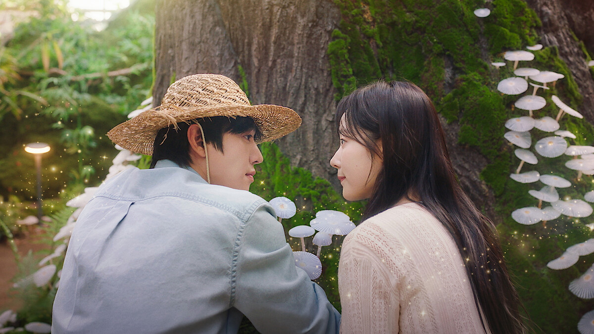 Ahn Hyo-seop as Matthew and and Chae Won-been as Ye-jin observe mushrooms in 'Sold Out on You.'